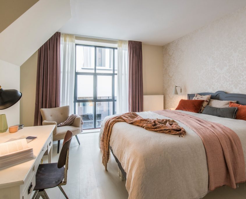 One of our beautifully furnished bedrooms with working area at Morton Place Louise in Brussels.