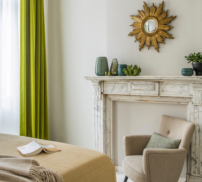 Marble fireplace and cozy beige reading chair