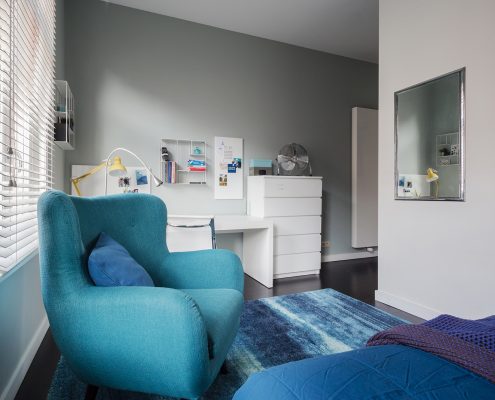 Blue chair across from mirror