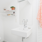 bathroom sink towel heating radiator with pink towel