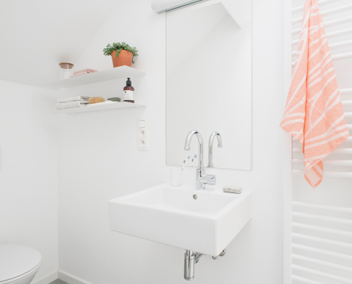 bathroom sink towel heating radiator with pink towel