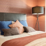 Room 1 close up of orange bed and blue pillows