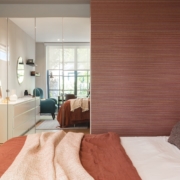 Bedroom with mirrored closet space and spectacular wallpaper