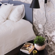 Damask wallpaper and bedside lamp, details from rooms for rent