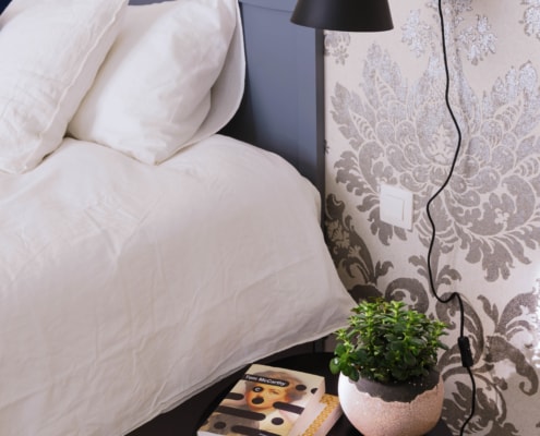 Damask wallpaper and bedside lamp, details from rooms for rent