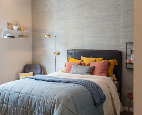 Grey wall room bed and white shelves