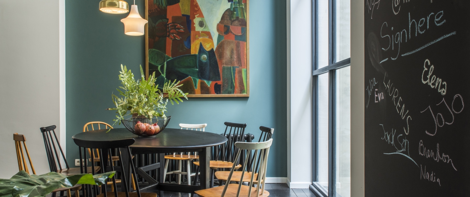 Round dining table with orginal artwork in shared housing