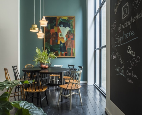 Round dining table with orginal artwork in shared housing