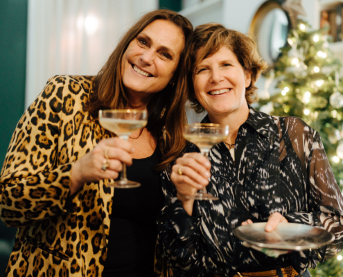 Tanya and Ivonne from Morton Place celebrating with champagne at the annual Christmas party in Brussels.